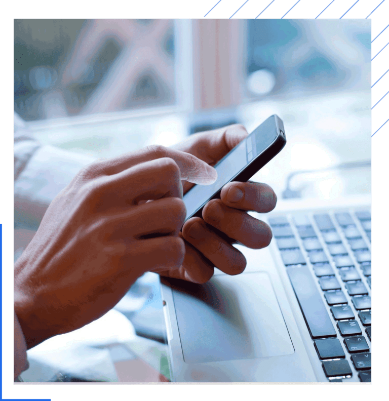Person using smartphone and laptop